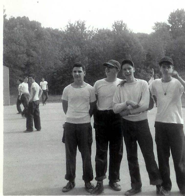 Four juniors standing in the handball court space across he river road from the main ball fields. Tully, McCormick, Keough and O'Shea. 