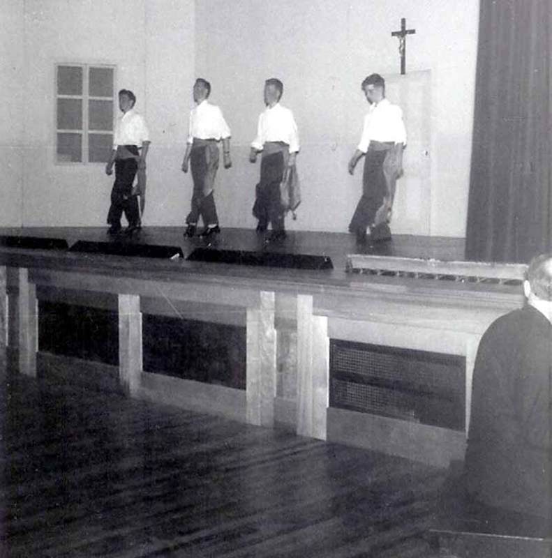 Irish Dancers on the stage of the new gym.  Bill O'Shea recognises Larry Keough and Bill Maker. Dancer on the right may be Mullins.  Pianist is either Brother Placid Robert of Brother William Lavigne.