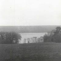 River view from the main house. The architects Carrère and Hastings shared the project with Hastings designing the buildings and Carrère the landscaping.  Trees were spaced to frame Payne's yacht, the Aphrodite, which was moored in the opening.