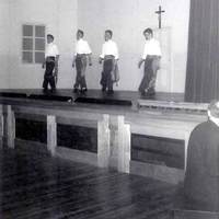 Irish Dancers on the stage of the new gym.  Bill O'Shea recognises Larry Keough and Bill Maker. Dancer on the right may be Mullins.  Pianist is either Brother Placid Robert of Brother William Lavigne.