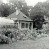 The greenhouse and adjacent building as it existed in the 1950s.  The original consisted of a 40 foot high dome in the center with two sections of lower greenhouse on both sides of the dome